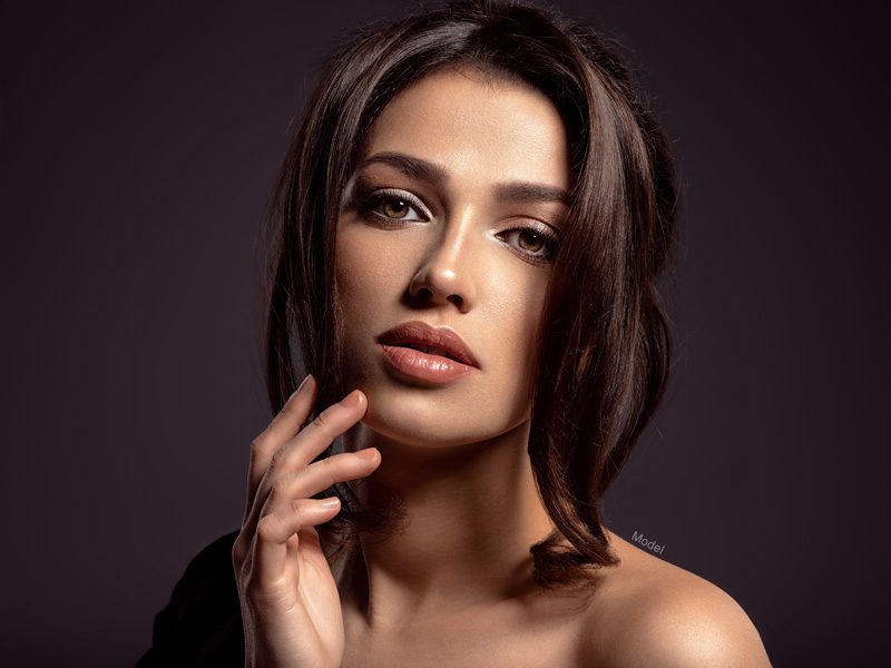 Headshot of female model with bright clear skin and plump lips